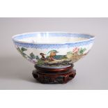 A 20TH CENTURY CHINESE EGGSHELL BOWL & HARDWOOD STAND, the bowl finely decorated with scenes of