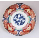 A SMALL 19TH CENTURY JAPANESE IMARI LOBED PORCELAIN PLATE, decorated in a traditional style