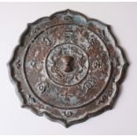 A GOOD CHINESE BRONZE SCALLOPED MING MIRROR, with decorated character marks surrounding the