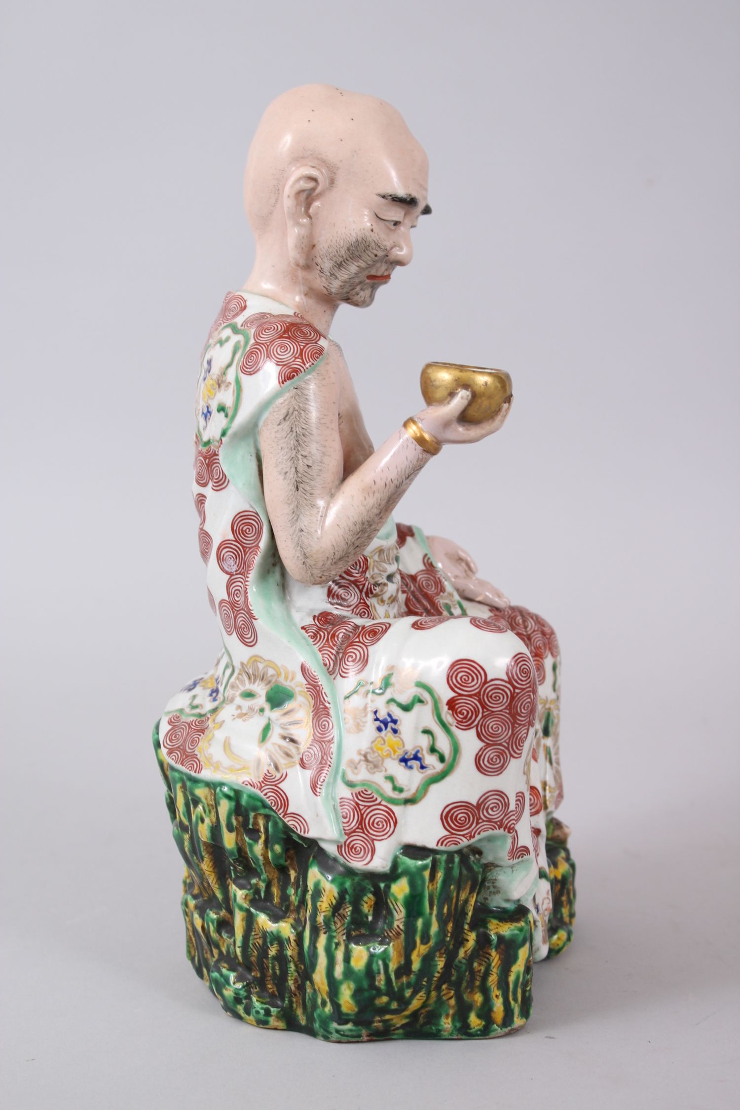 A GOOD JAPANESE KUTANI PORCELAIN MODEL OF AN ARHAT, the arhat with a low expression upon his face, - Image 2 of 8