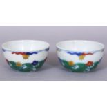 A SMALL PAIR OF CHINESE DOUCAI PORCELAIN WINE CUPS, each decorated with stylised waves bearing