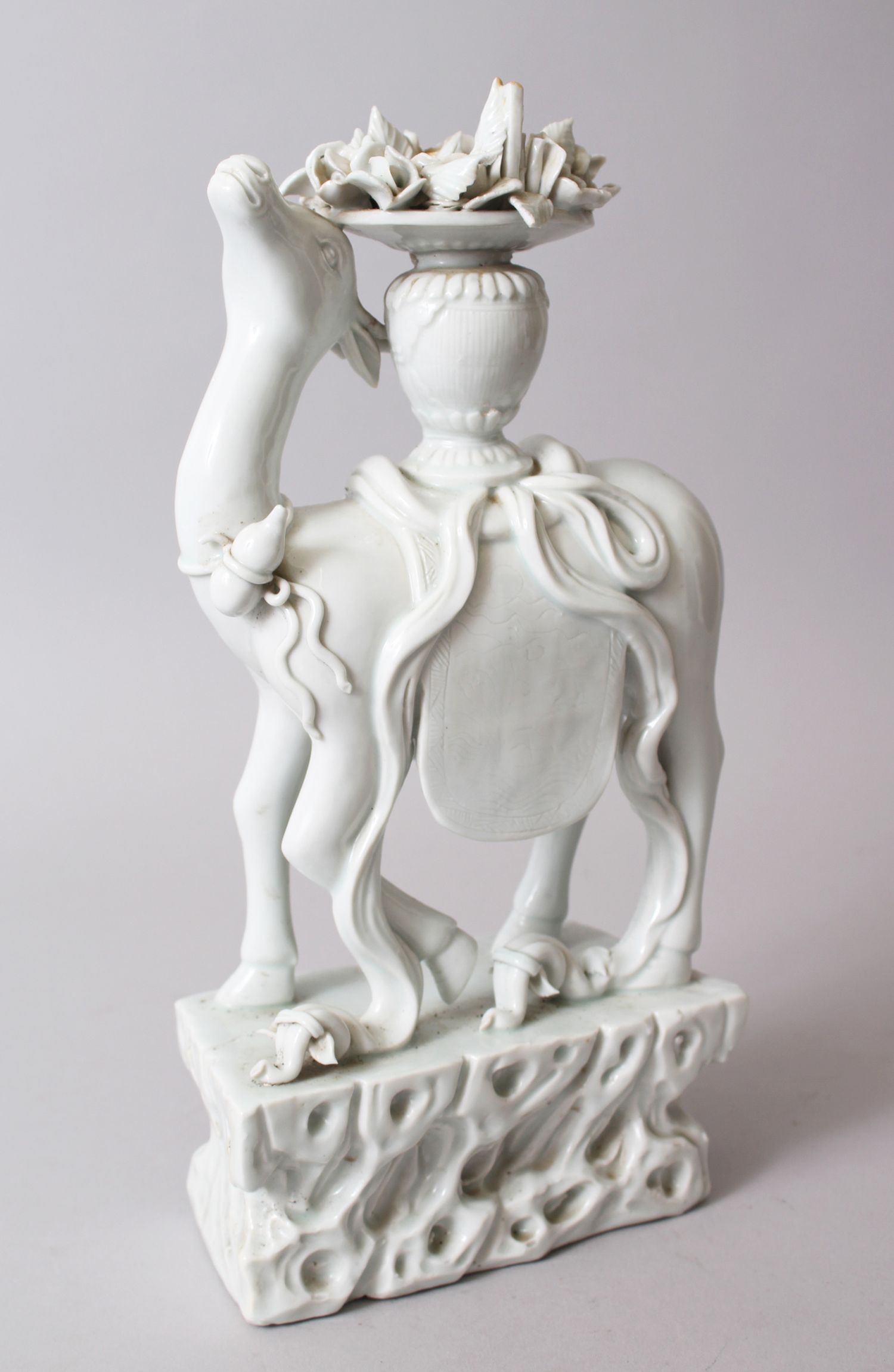 A GOOD 19TH CENTURY CHINESE CHINE DE BLANC PORCELAIN FIGURE OF A DEER, stood upon a rock formed base