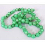 A CHINESE GREEN HARDSTONE NECKLACE, composed of spherical beads, each bead 0.3in diameter, approx.