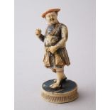 A 19TH CENTURY CARVED IVORY GAME PIECE FIGURE, stood in a waling pose with his let foot aloft,