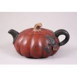 A 20TH CENTURY CHINESE PUMPKIN FORM YIXING CLAY TEAPOT, of pumpkin form and decorated with vine, the