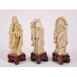 THREE CHINESE 19TH / 20TH CENTURY SOAPSTONE FIGURES OF SHOU LAO AND OTHERS, all three on carved