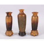 A GOOD GARNITURE OF THREE RHINO HORN TURNED VASES ON STANDS, 12cm x 11cm high. Weight 234gms.