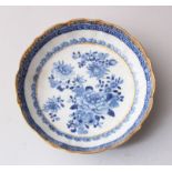 A SMALL CHINESE 18TH CENTURY BLUE & WHITE PORCELAIN SAUCER, decorated with floral scenes and with