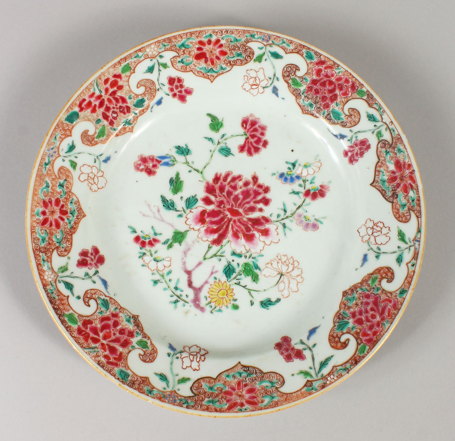 AN 18TH CENTURY CHINESE FAMILLE ROSE PORCELAIN PLATE, painted to its centre with peony and other