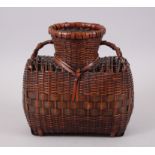 A FINE JAPANESE MEIJI PERIOD WOVEN BAMBOO IKEBANA BASKET ARTIST SIGNED, the basket woven in to a