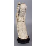 AN EARLY 20TH CENTURY CHINESE CARVED IVORY FIGURE OF SHOU LAO, together with a fixed wood stand, the