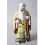 A GOOD CHINESE PORCELAIN MODEL OF GOD SHOU LOU, stood holding a fruit of some kind, wearing