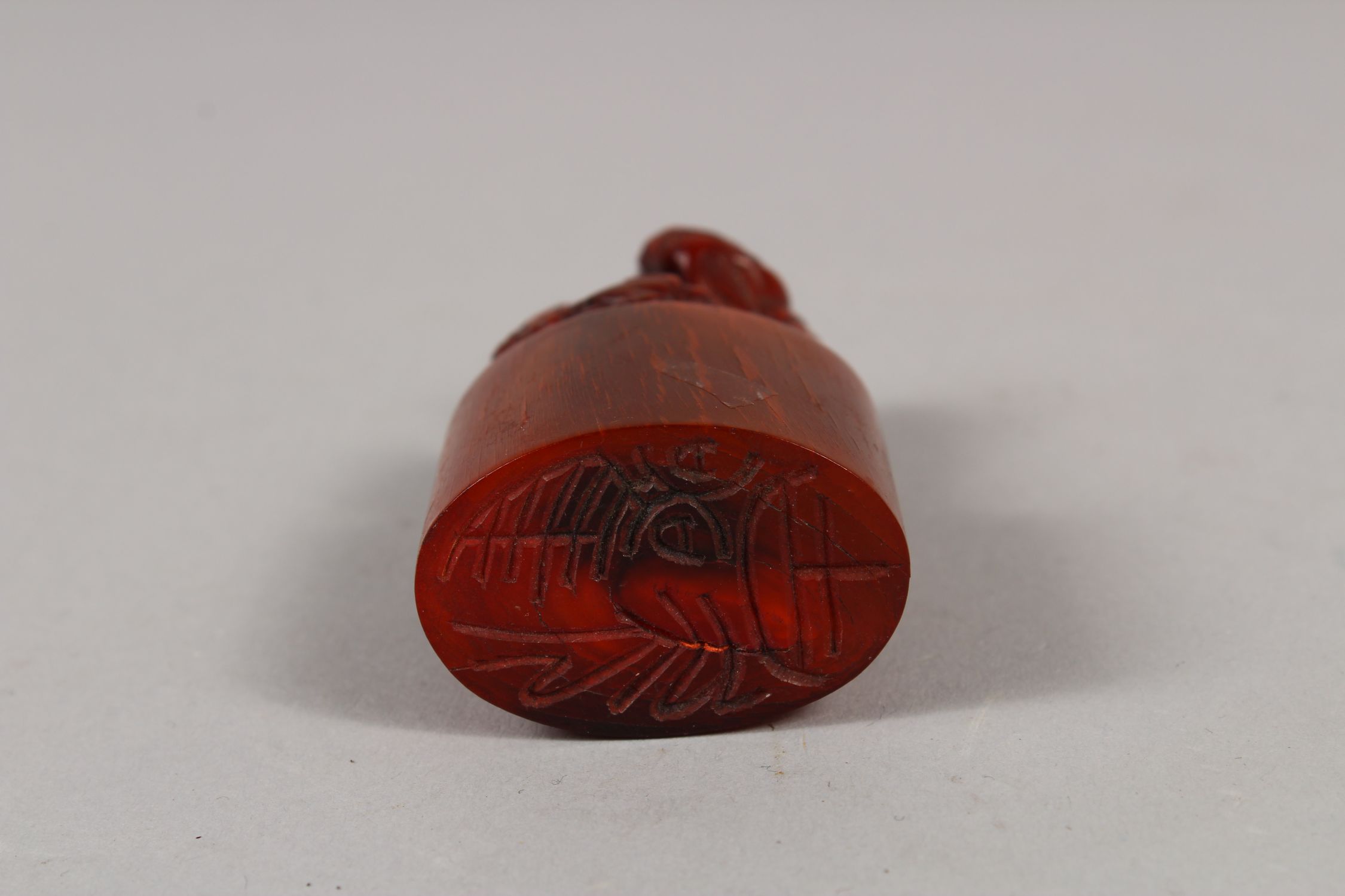 AN EARLY 20TH CENTURY CHINESE HORN SEAL, well carved with a Buddhistic lion and pup on an oval- - Image 3 of 3