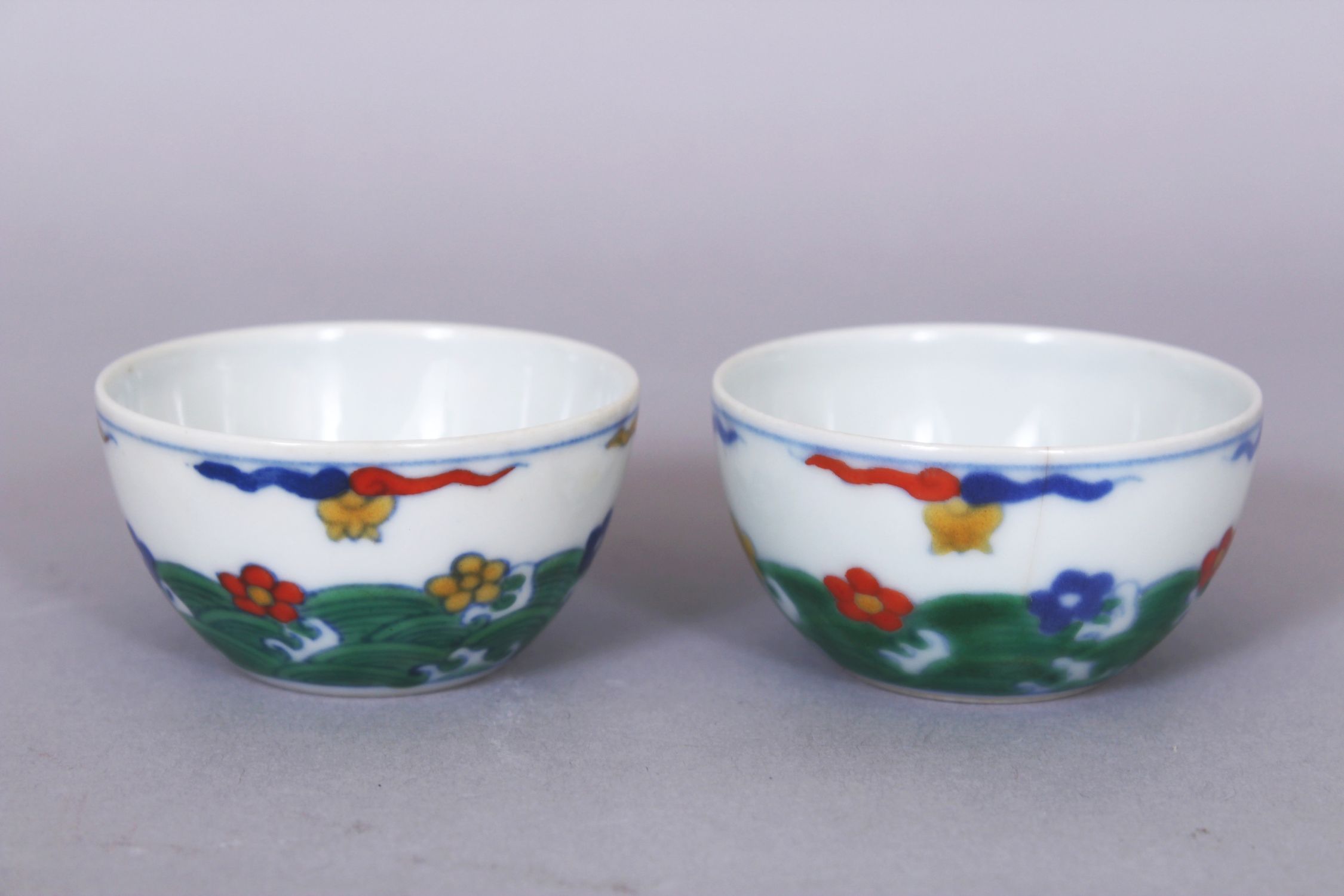 A SMALL PAIR OF CHINESE DOUCAI PORCELAIN WINE CUPS, each decorated with stylised waves bearing - Image 3 of 6