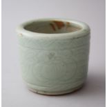 A 19TH CENTURY CHINESE CELADON PORCELAIN BRUSH POT, with moulded decoration of formal scrolling, 7.