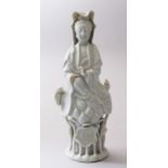 A SMALLER 19TH CENTURY CHINESE BLANC DE CHINE PORCELAIN FIGURE OF GUANYIN, stood upon a lotus