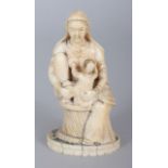 AN UNUSUAL 19TH CENTURY GOANESE IVORY CARVING OF A SEATED LADY, possibly the Virgin Mary, suckling
