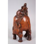 A CHINESE 19TH CENTURY CARVED WOODEN FIGURE OF A BULL, the animal stood with his head looking back