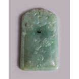 A CHINESE CARVED JADEITE TABLET / PENDANT, depicting two lion dogs, 6.5cm X 3,8cm