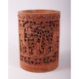 A CHINESE 19TH CENTURY BAMBOO BRUSH POT, the main panel carved with figures in a garden setting, two