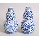 TWO CHINESE 19TH CENTURY BLUE & WHITE DOUBLE GOURD VASES, both painted with typical scenes of