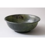 A 19TH / 20TH CENTURY CHINESE SPINACH GREEN JADE BOWL, the base with a chinese script mark, 12.5cm