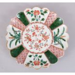 AN EARLY 18TH CENTURY JAPANESE ARITA FLUTED SAUCER, decorated with floral and geometric patterns,