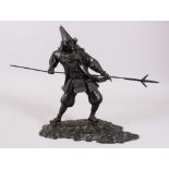 A JAPANESE MEIJI PERIOD BRONZE OKIMONO OF A SAMURAI WARRIOR, stood upon a rocky outcrop base in a