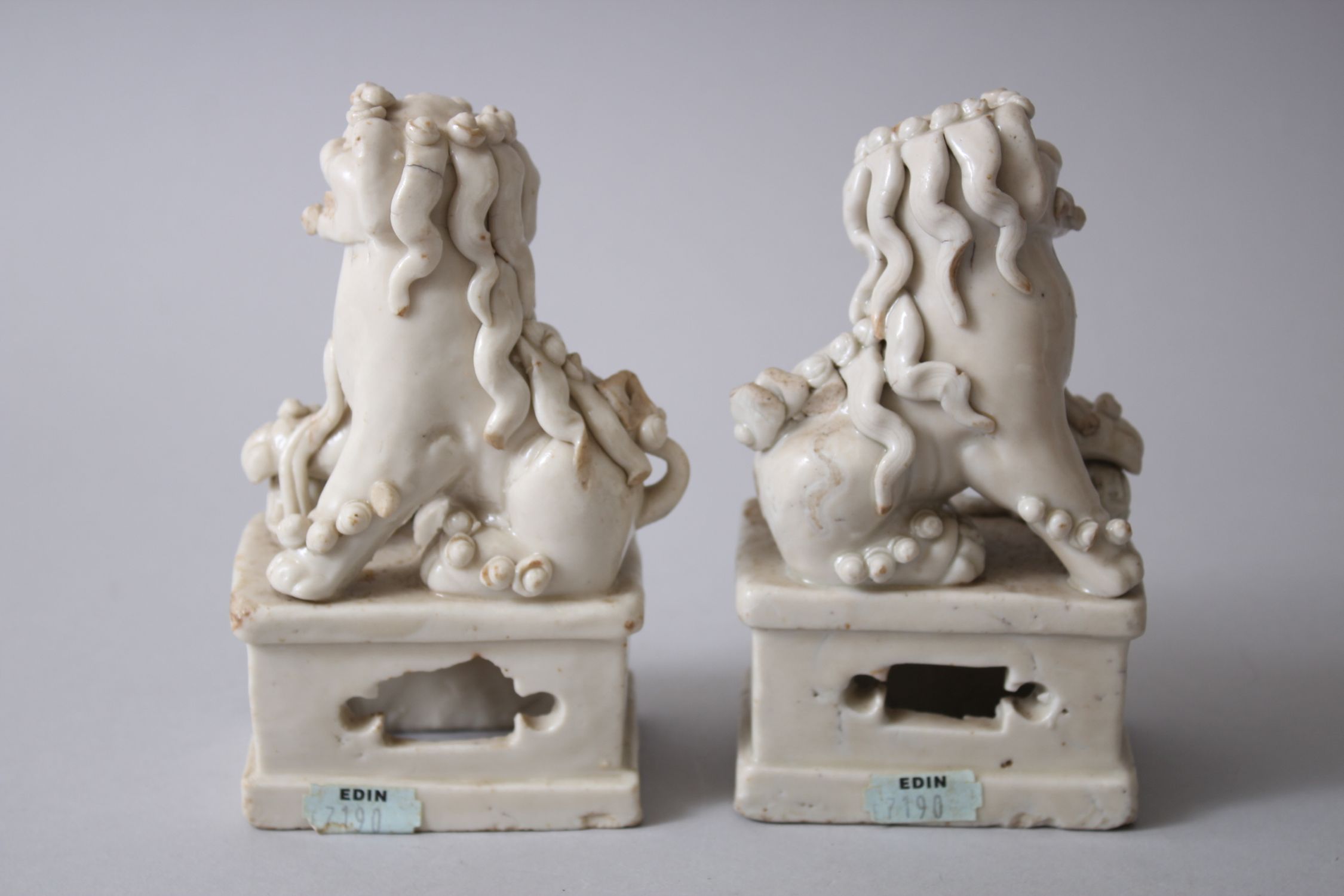 PAIR OF 19TH CENTURY CHINESE CHINE DE BLANC / DEHUA LION DOG FIGURES, both seated upon pierced - Image 3 of 4