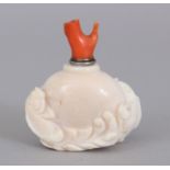 A 19TH/20TH CENTURY WHITE CORAL SNUFF BOTTLE & RED CORAL STOPPER, the sides carved in high relief