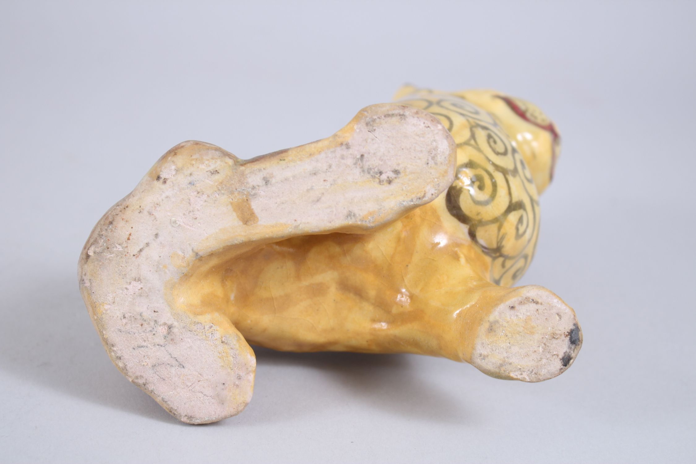 A 19TH CENTURY YELLOW GLAZED PERSIAN LION, with stylized painted mane design, 14cm high x 14,5cm - Image 6 of 6