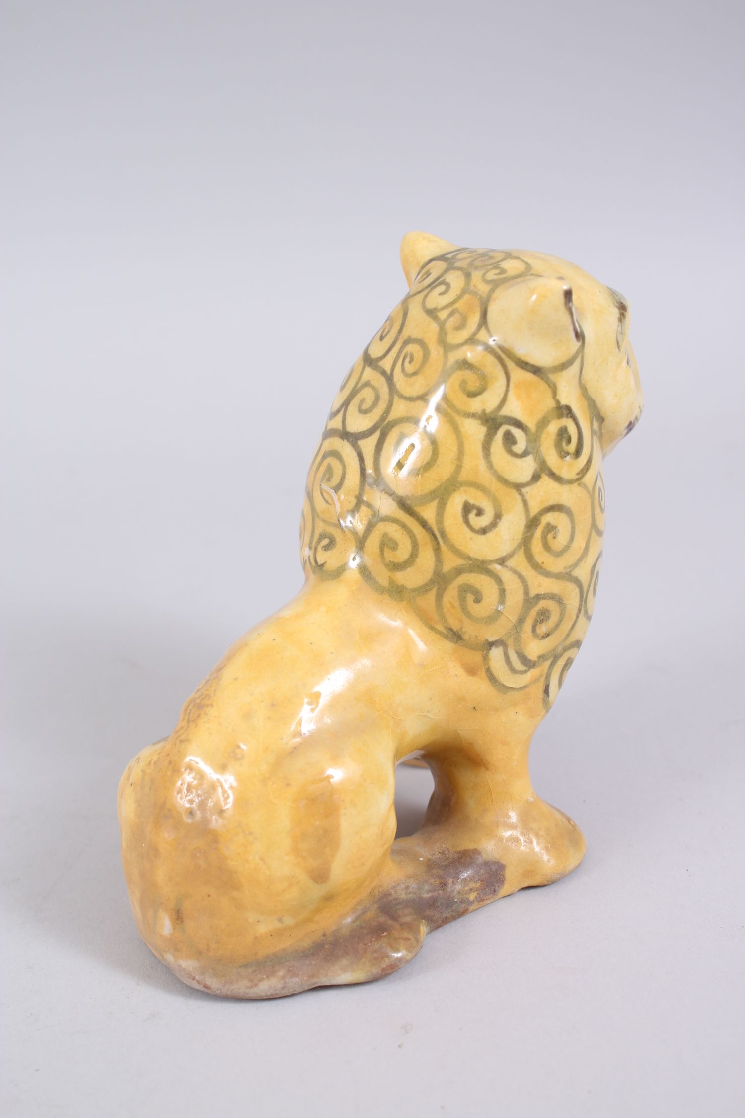 A 19TH CENTURY YELLOW GLAZED PERSIAN LION, with stylized painted mane design, 14cm high x 14,5cm - Image 4 of 6