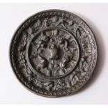 A GOOD CHINESE BRONZE MING MIRROR, interior with scenes of birds and lion dogs, 10 cm diameter.