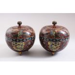 A GOOD PAIR OF JAPANESE MEIJI PERIOD CLOISONNE LIDDED KORO, both stood on three brass feet, upon a