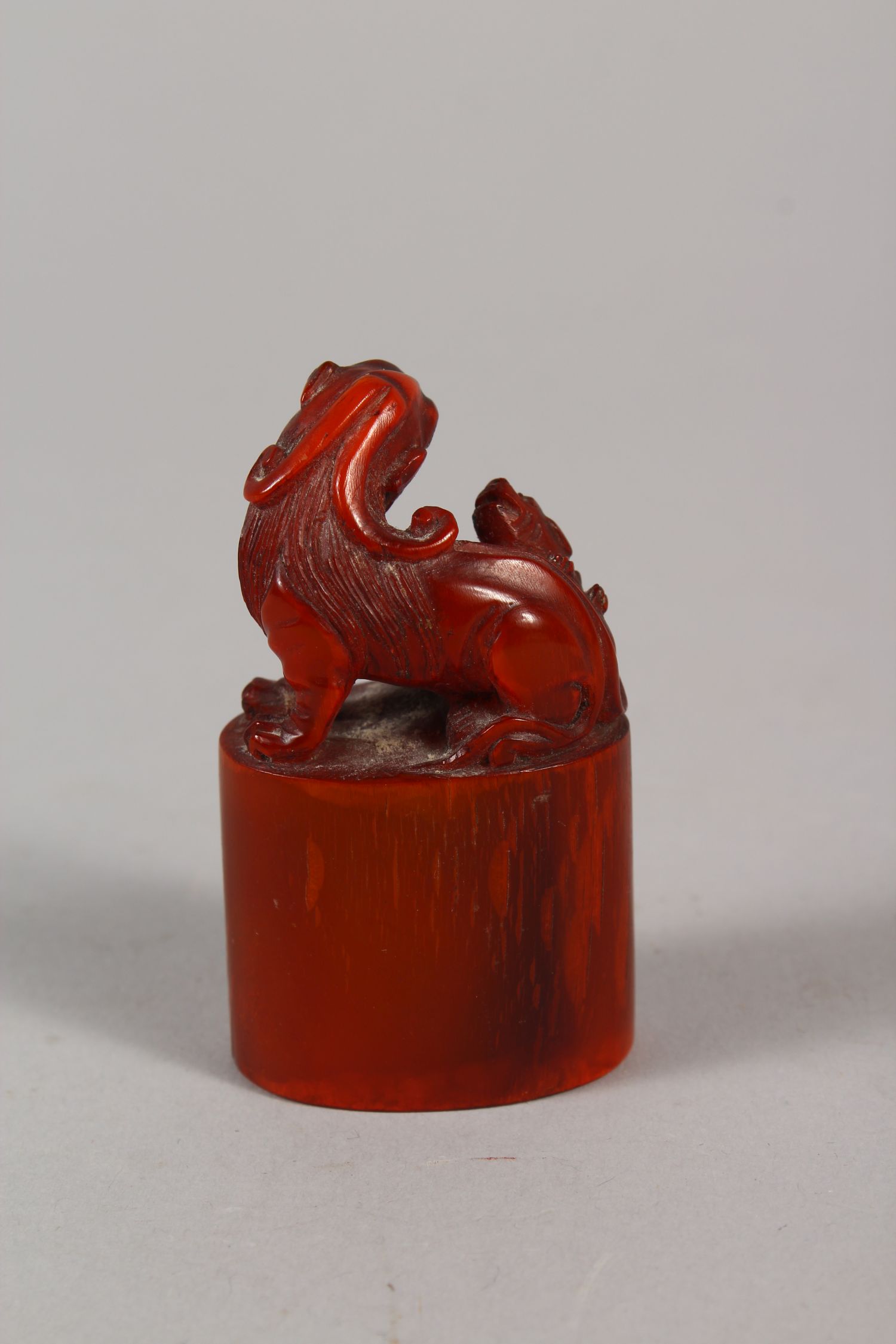 AN EARLY 20TH CENTURY CHINESE HORN SEAL, well carved with a Buddhistic lion and pup on an oval- - Image 2 of 3