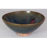 A CHINESE JUN WARE PURPLE SPLASH CERAMIC BOWL, the glaze falling short of the foot, 19.3cm