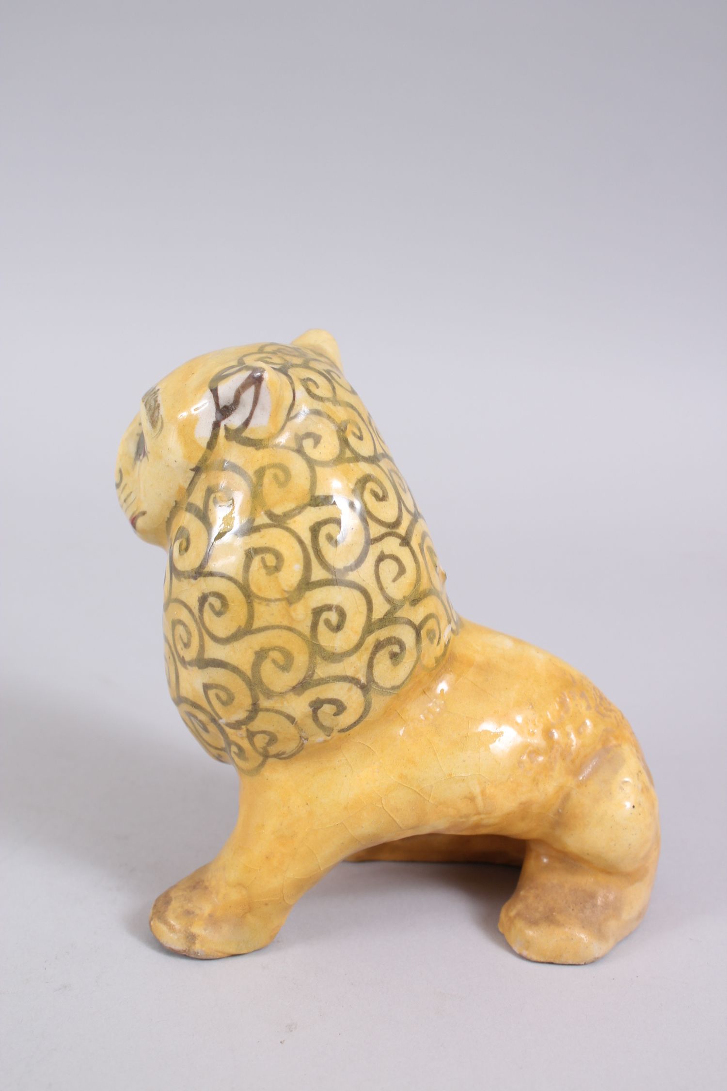A 19TH CENTURY YELLOW GLAZED PERSIAN LION, with stylized painted mane design, 14cm high x 14,5cm - Image 3 of 6
