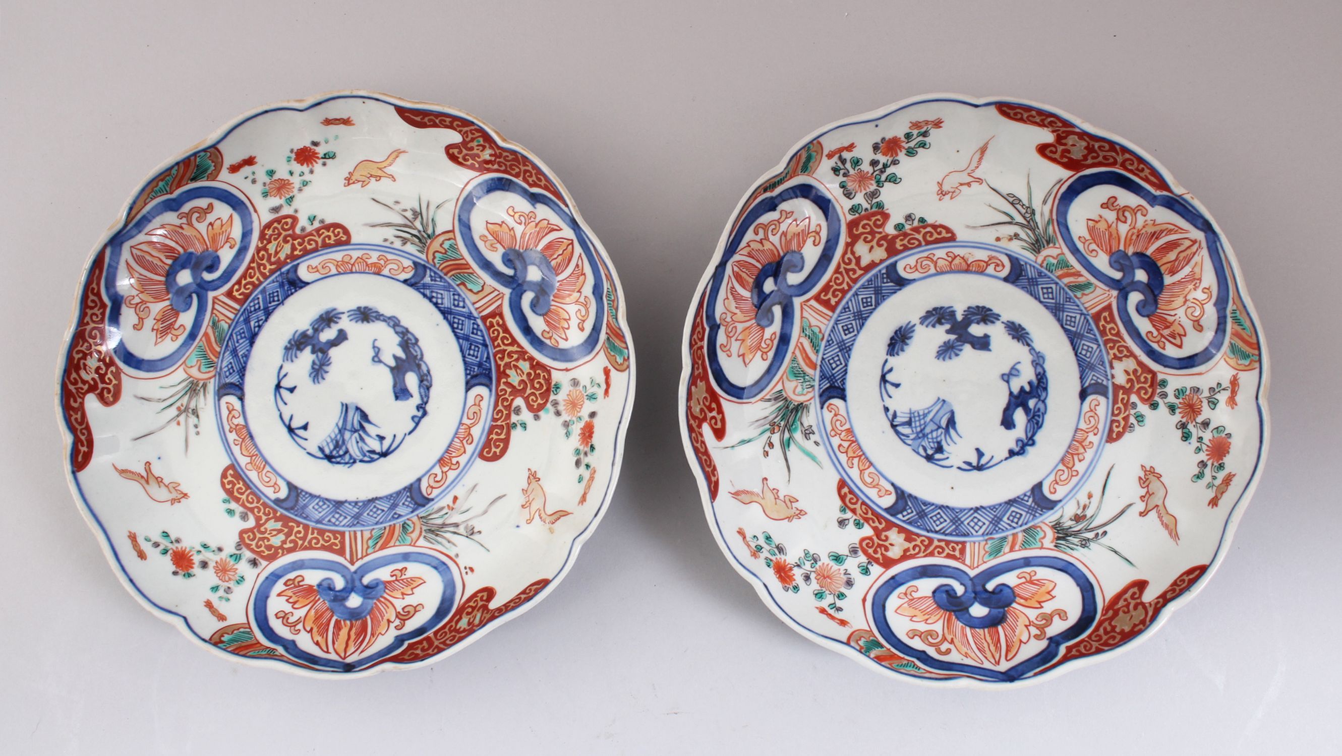 A PAIR OF 19TH CENTURY JAPANESE IMARI LOBED PORCELAIN PLATES, decorated with traditional imari