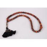 A 19TH CENTURY QING DYNASTY CHINESE RHINOCEROS HORN & AMBER ROSARY / NECKLACE, comprising of 55