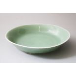 A CHINESE CELADON GLAZED DISH DAOGUANG SEAL MARK & PERIOD, with a flared side and a wedge foot, with