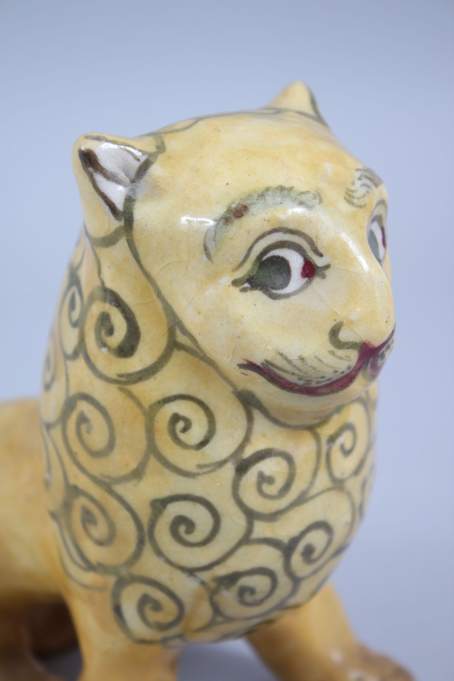 A 19TH CENTURY YELLOW GLAZED PERSIAN LION, with stylized painted mane design, 14cm high x 14,5cm - Image 5 of 6