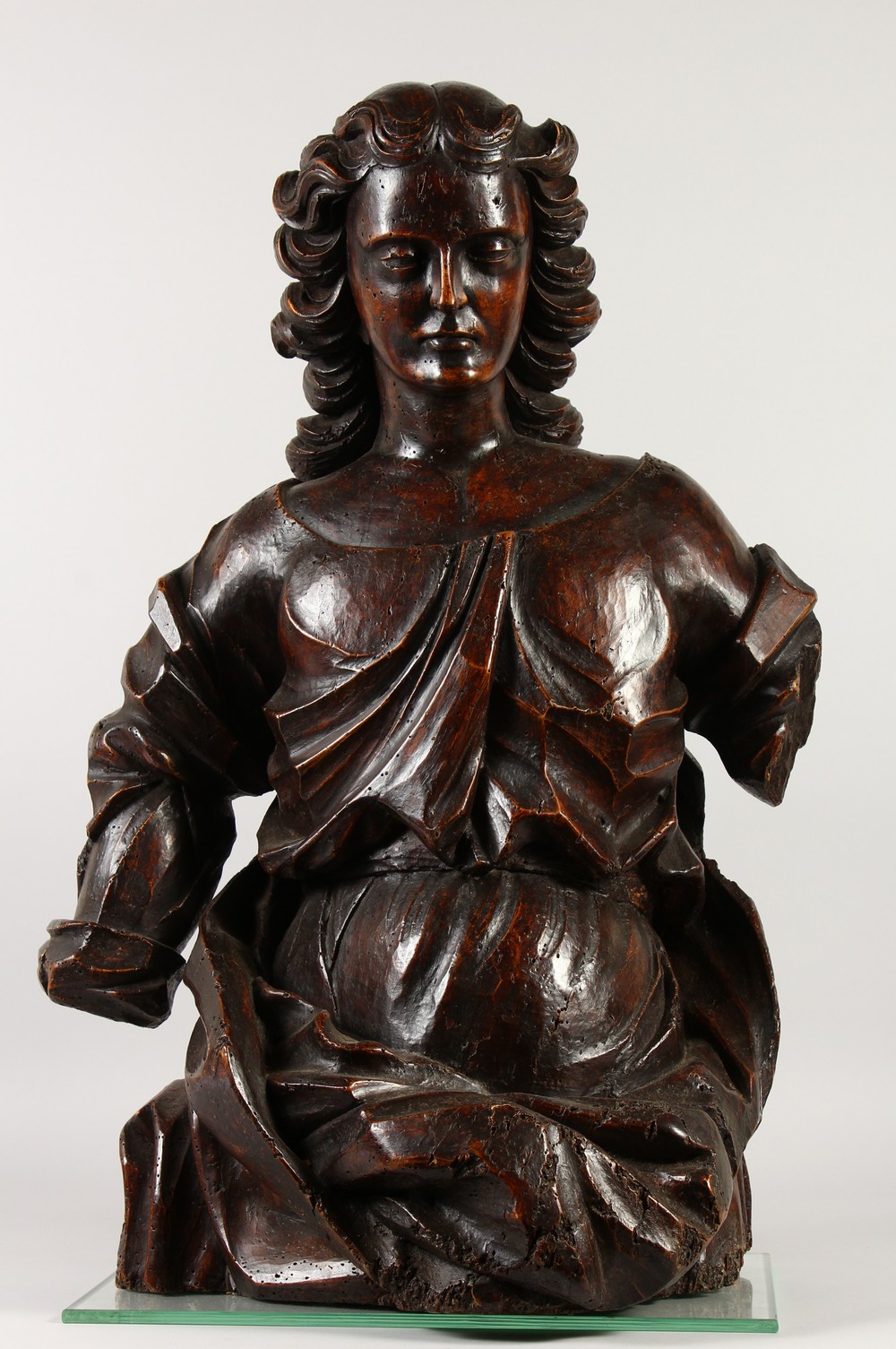 A 17TH - 18TH CENTURY ITALIAN CARVED FRUITWOOD ANGEL, half length. 74cms high.