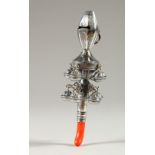 A SILVER RATTLE WITH WHISTLE, and coral mouthpiece. 13cms long.