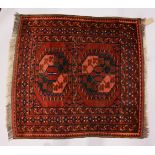 A SMALL PERSIAN RUG, rust ground with two large motifs. 106cms x 100cms.