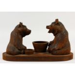 A GROUP OF TWO CARVED WOOD BEARS. See label on reverse. 30cms long.