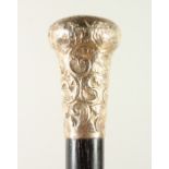 A SILVER HANDLE CANE with repousse silver handle. 90cms long.