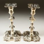 A MATCHING PAIR OF CAST SILVER CANDLESTICKS, with shell cast sconces, knopped stems on shell cut
