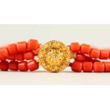 A CORAL BEAD NECKLACE WITH GOLD CLASP.