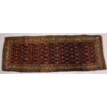 A PERSIAN LONG RUG / RUNNER, dark blue ground with stylized floral decoration. 315cms x 110cms.