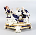 A LARGE ROYAL DUX PORCELAIN GROUP, "THE TEA PARTY" on an oval base. 13ins high.